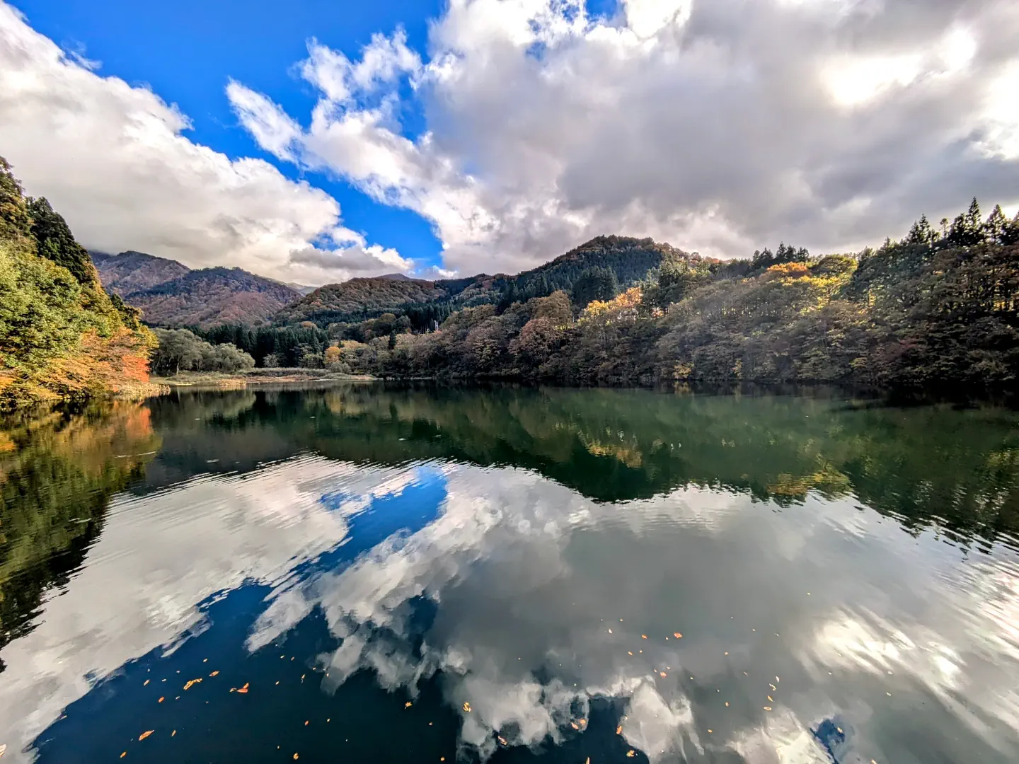 Lake Daigenta in Yuzawa surrounded by vibrant autumn colors.
